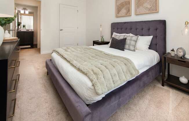 a bedroom with a bed and a dresser