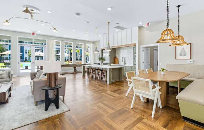 A modern living room with a dining area and a kitchen in the background.
