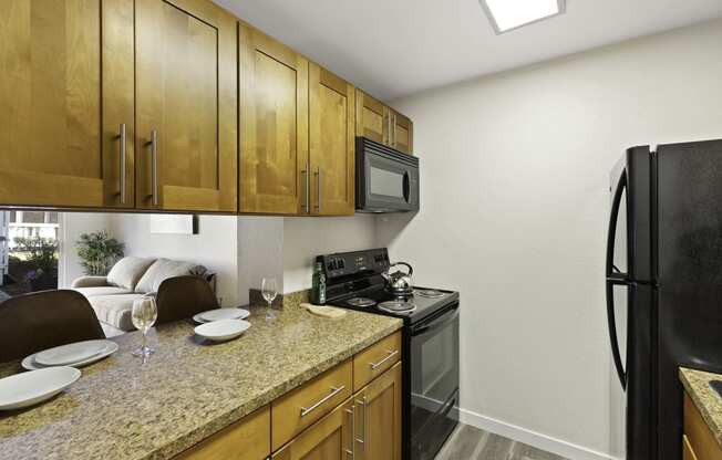 a kitchen with wooden cabinets and a granite counter top