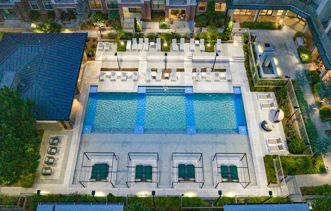 an aerial view of resort style pool at night at The Hendrix, Georgia