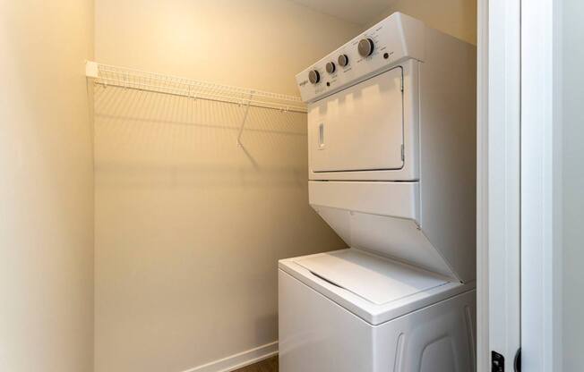 A white oven and dishwasher in a small room.