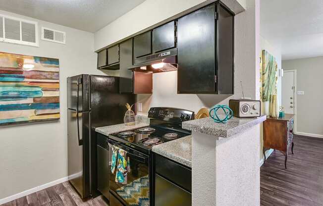 a kitchen with a stove top oven next to a refrigerator