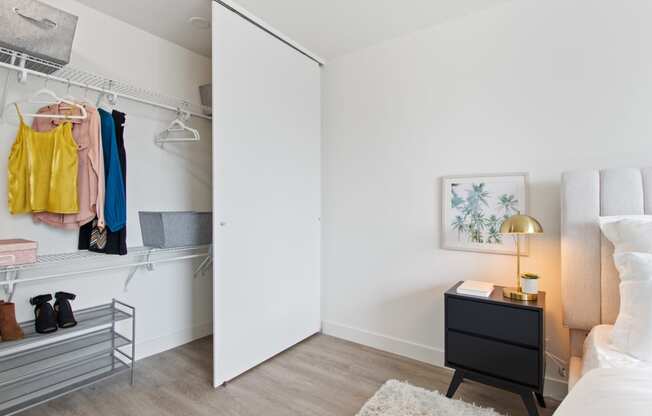 a bedroom with white walls and a closet with a sliding door