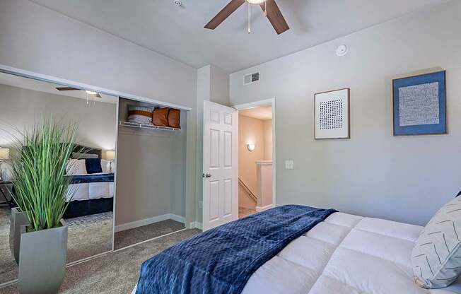 A bedroom with a bed, a ceiling fan, and a potted plant.at Palazzo Townhomes, Phoenix, 85008  