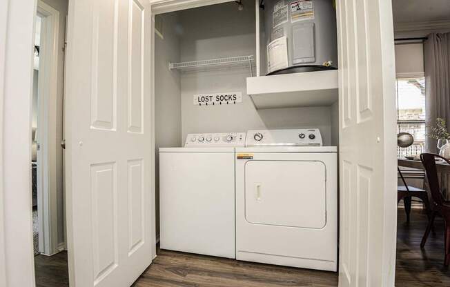a washer and dryer in a laundry room with a door open