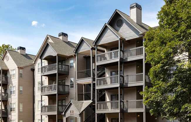 A large apartment complex with balconies and multiple stories.
