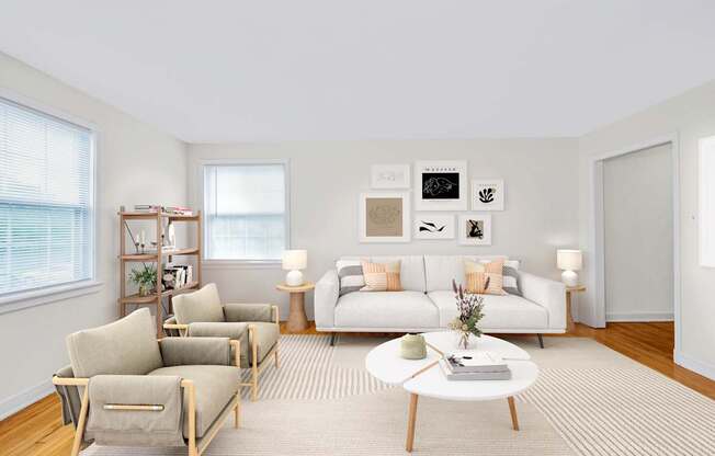 A living room with a white couch, a coffee table, and a rug.