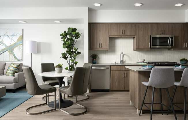a living room and kitchen with a table and chairs