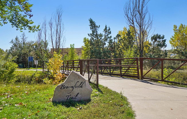 A sign that says Brownfield Trail is in front of a gate.