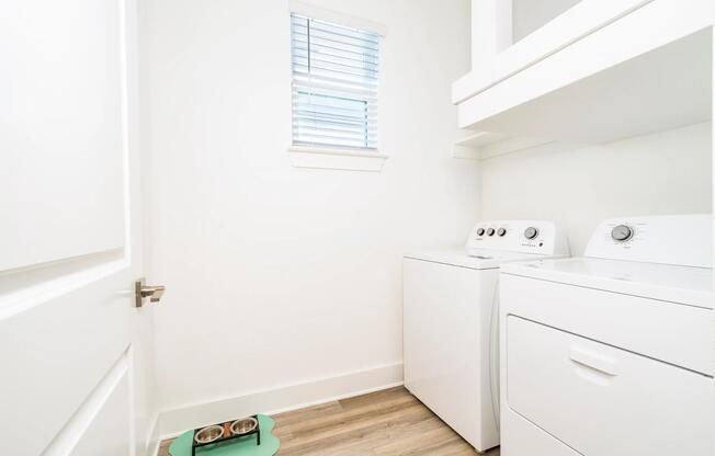 A dedicated laundry room with full-size appliances and added storage keeps daily tasks organized and conveniently tucked away.