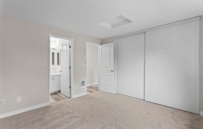 A room with a carpeted floor and white walls.
