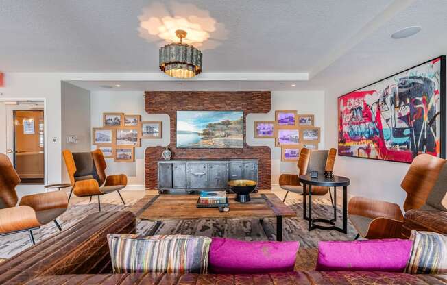 a living room with a fireplace and a bunch of pictures on the wall