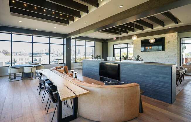 A modern office space with a long wooden table and chairs.