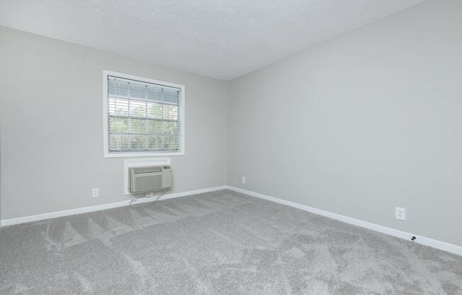 a bedroom with a large window