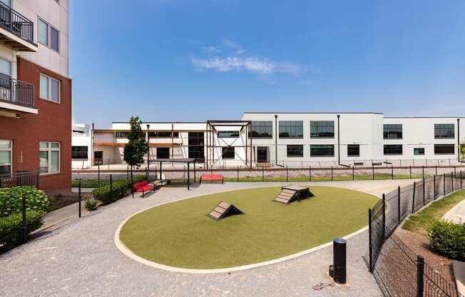 a courtyard with benches and a building in the background