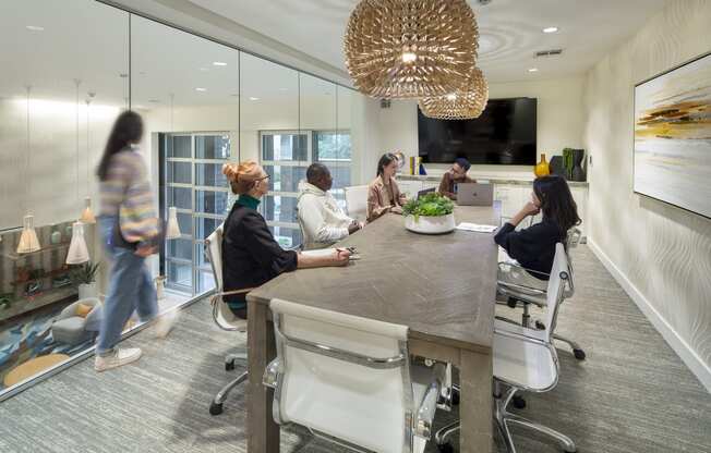 a group of people sitting around a table in an office