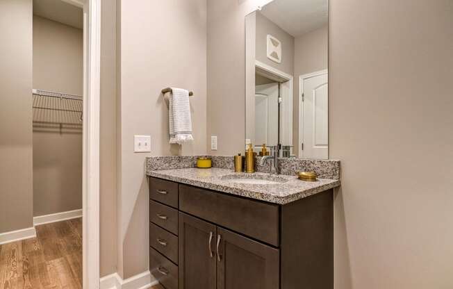 the retreat apartments renovated bathroom with granite counter top and mirror
