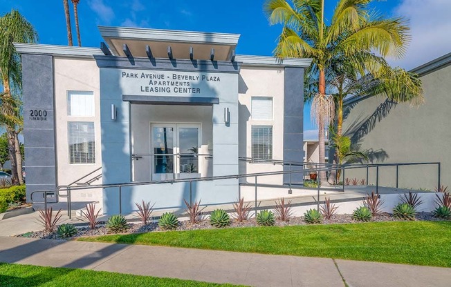 a building with a palm tree in front of it at  Park Avenue Apartments, Long Beach