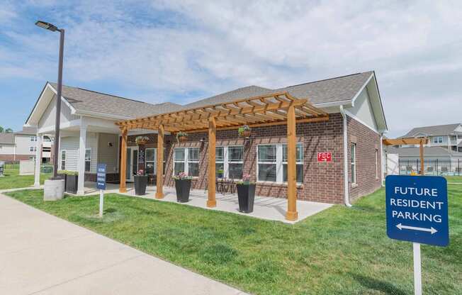 Crossing at Grove City Clubhouse building with a pergola and a sign