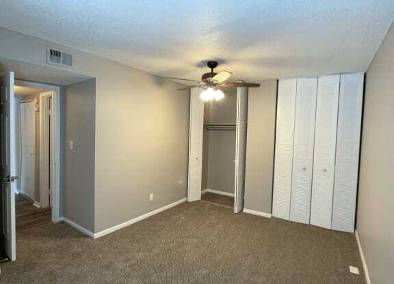 Bedroom with carpet and large closet