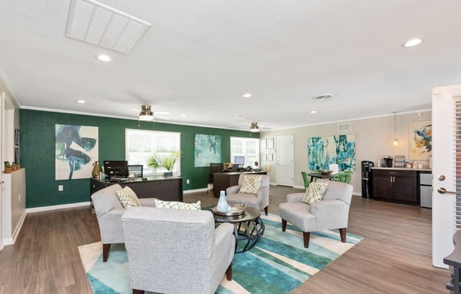 Leasing Office and Clubhouse with White Armchairs on Area Rug with Coffee Tables at South Square Townhomes, North Carolina, 27707
