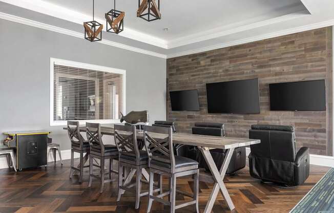 A modern dining room with a wooden table and chairs.