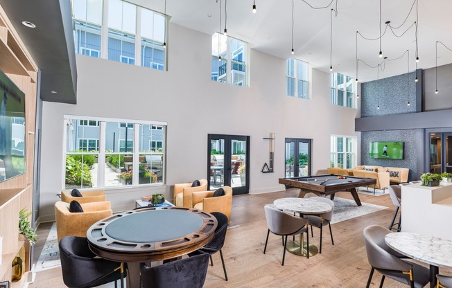 Unwind and entertain at Modera Montville's stylish clubroom, featuring a poker table, pool table, and multiple TVs. It's the perfect spot for game nights and social gatherings!