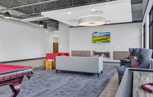 a room with a pool table and couches