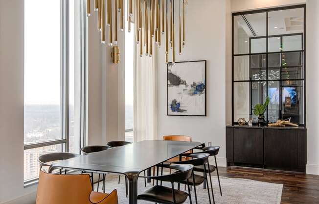 a dining room with a large table and chairs and a large window