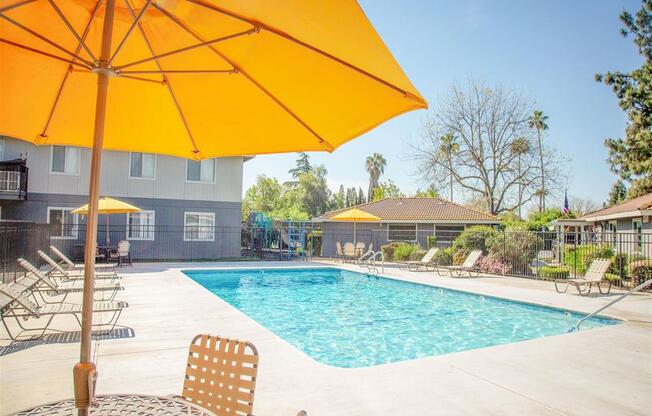 Pool With Sunning Deck at Courtyard at Central Park Apartments, California, 93722