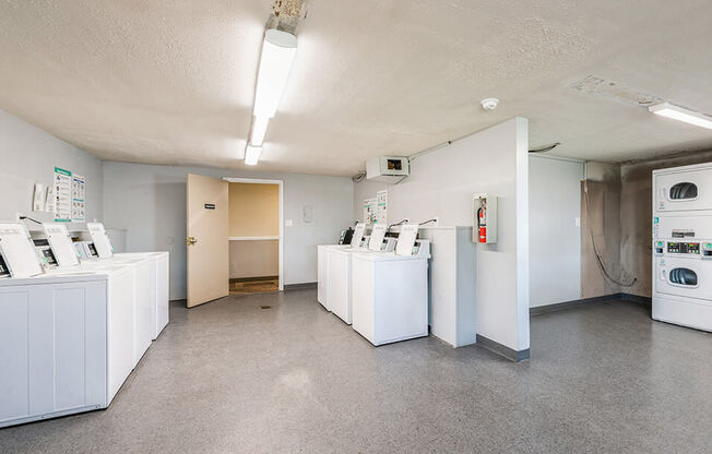 an empty laundry room with washer and dryer machines