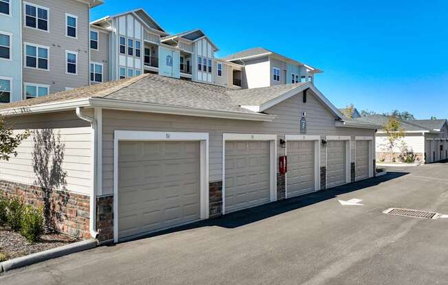 A row of garages in front of a building.