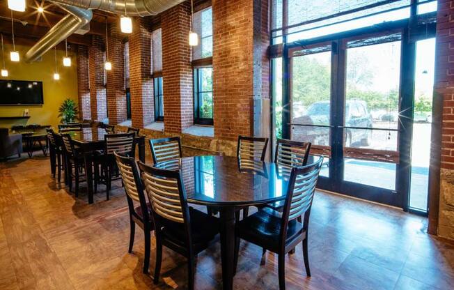 Lofts at Lafayette Square clubroom with tables, chairs and oversized windows