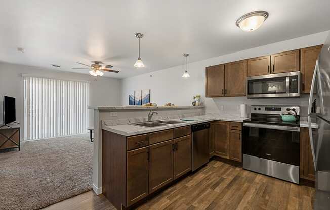 a kitchen with wooden cabinets and stainless steel appliances