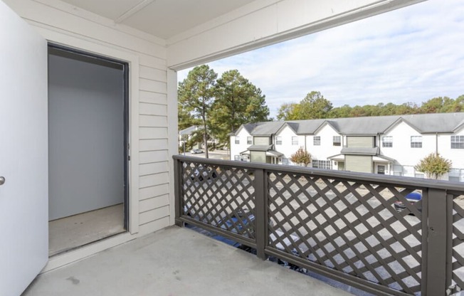 the view from the balcony of a home with a garage door open