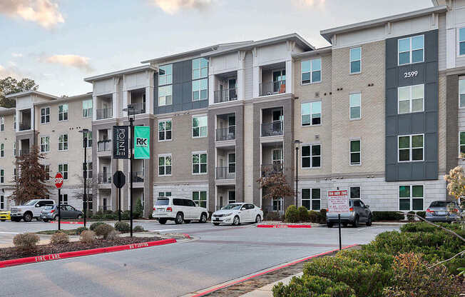 an apartment building with cars parked in front of it