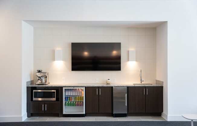 a kitchen with a counter and a microwave and a television at 20 Midtown, Alabama, 35233