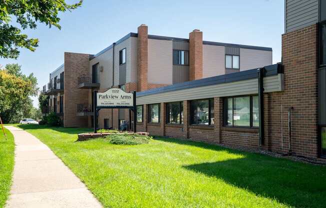 The image shows a building with the name  Bismarck, ND Parkview Arms Apartments