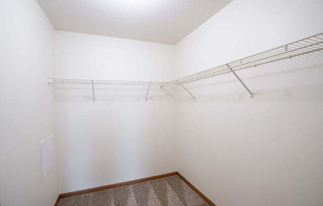 Empty room with a shelf and carpeted floor. Fargo, ND Park Place Apartments