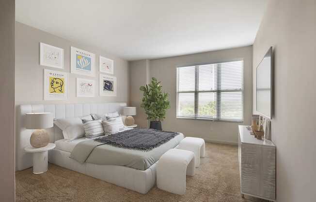 a white bedroom with a bed and a mirror