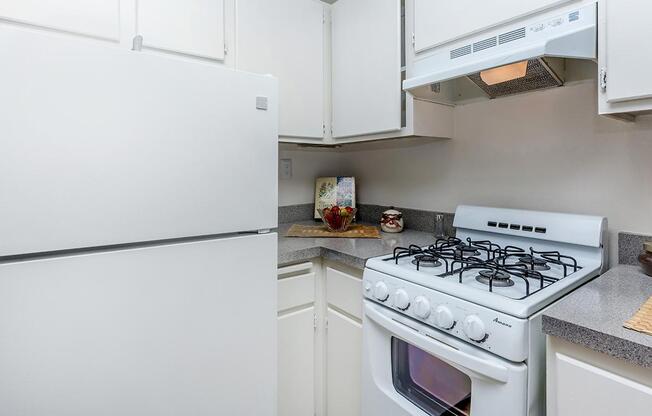 a kitchen with a white stove top oven sitting inside of a refrigerator