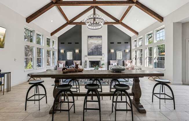 A large dining room with a wooden table and chairs.