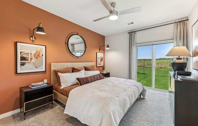 a bedroom with a bed and a ceiling fan