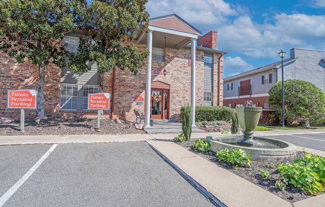Leasing office building with twin pillars and beautiful greenery at Magnolia apartments in Shreveport, LA