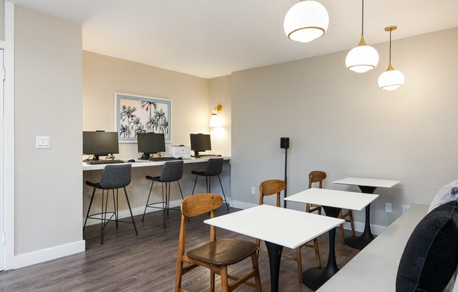 a dining room with tables and chairs and a counter with lamps