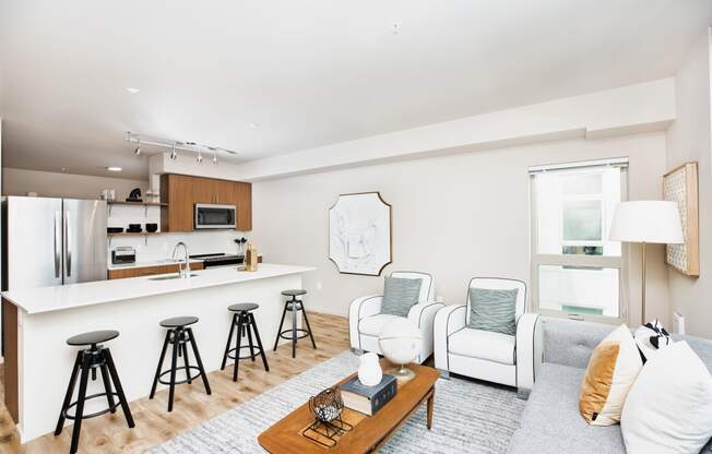 a living room with a kitchen and a couch at The Hayes on Stone Way, Seattle, WA