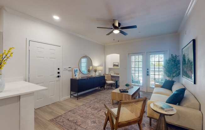 a living room with a ceiling fan and a couch