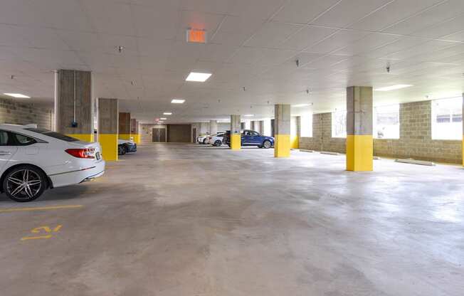 a parking garage with cars in it and an exit sign