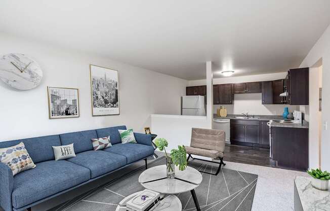 A living room with a blue couch and a coffee table.