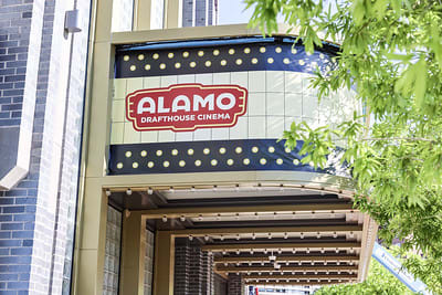 a building with a sign that says alamo drafthouse cinema